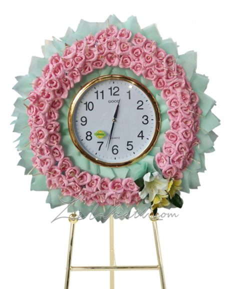 พวงหรีดสีเขียวมิ้นแบบนาฬิกา และดอกไม้สีชมพู